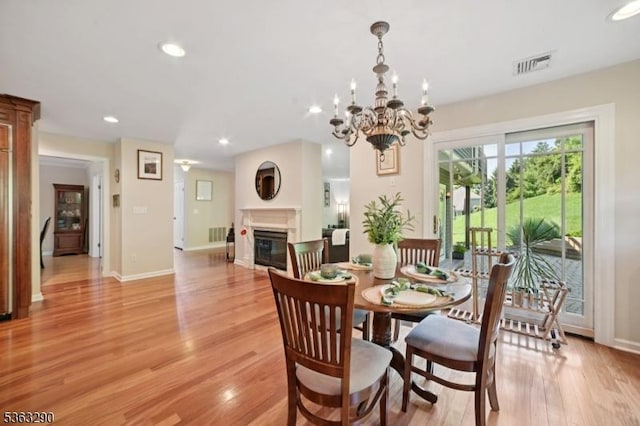 14 Mount Freedom Ave, Randolph Twp, NJ 07869 - dining space with a glass covered fireplace, light wood finished floors, recessed lighting, and a chandelier