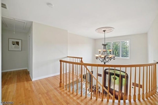 14 Mount Freedom Ave, Randolph Twp, NJ 07869 - hallway with attic access, an upstairs landing, light wood finished floors, and a chandelier