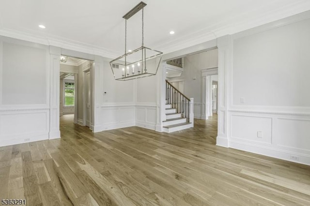 8 Cobblestone Ct, Warren Twp, NJ 07059 - unfurnished dining area with a decorative wall, a chandelier, light wood-style floors, stairs, and ornamental molding