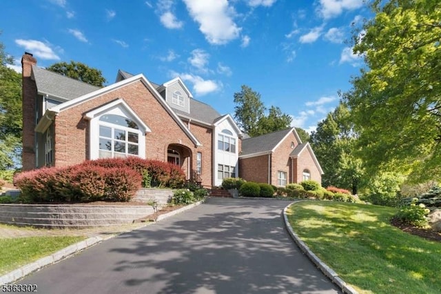 13 E Cove Ln, Morris Twp, NJ 07960 - traditional-style home with brick siding, a chimney, and a front lawn