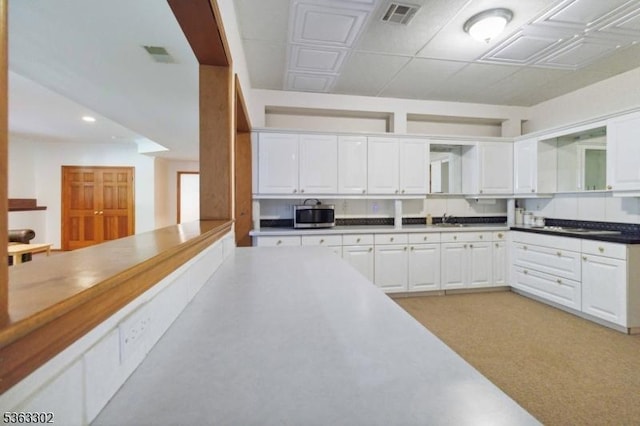 13 E Cove Ln, Morris Twp, NJ 07960 - kitchen with stainless steel microwave, white cabinetry, recessed lighting, and a sink