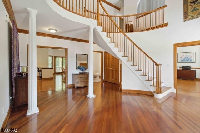 13 E Cove Ln, Morris Twp, NJ 07960 - entryway featuring decorative columns, stairs, wood finished floors, baseboards, and a towering ceiling