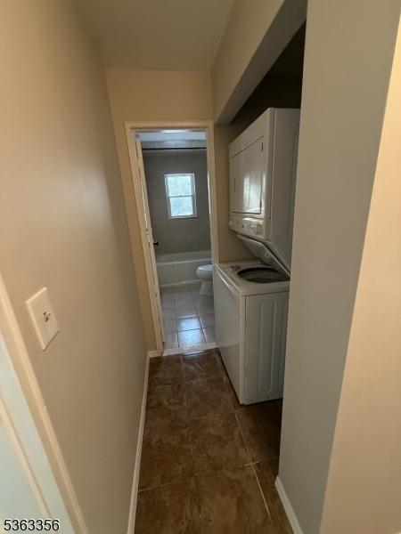 18 Deanna Dr Unit 43, Hillsborough Twp, NJ 08844 - corridor with dark tile patterned flooring and estacked washer and dryer