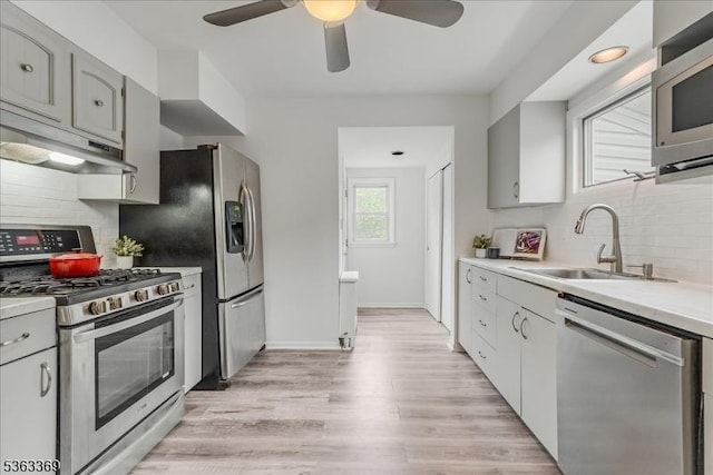 14 Prospect Pl, Morris Twp, NJ 07960 - kitchen featuring appliances with stainless steel finishes, under cabinet range hood, ceiling fan, decorative backsplash, and light wood finished floors