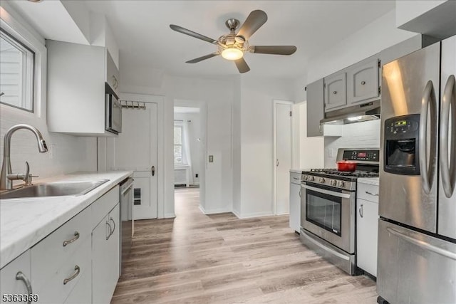 14 Prospect Pl, Morris Twp, NJ 07960 - kitchen featuring stainless steel appliances, under cabinet range hood, light wood-type flooring, a ceiling fan, and light countertops