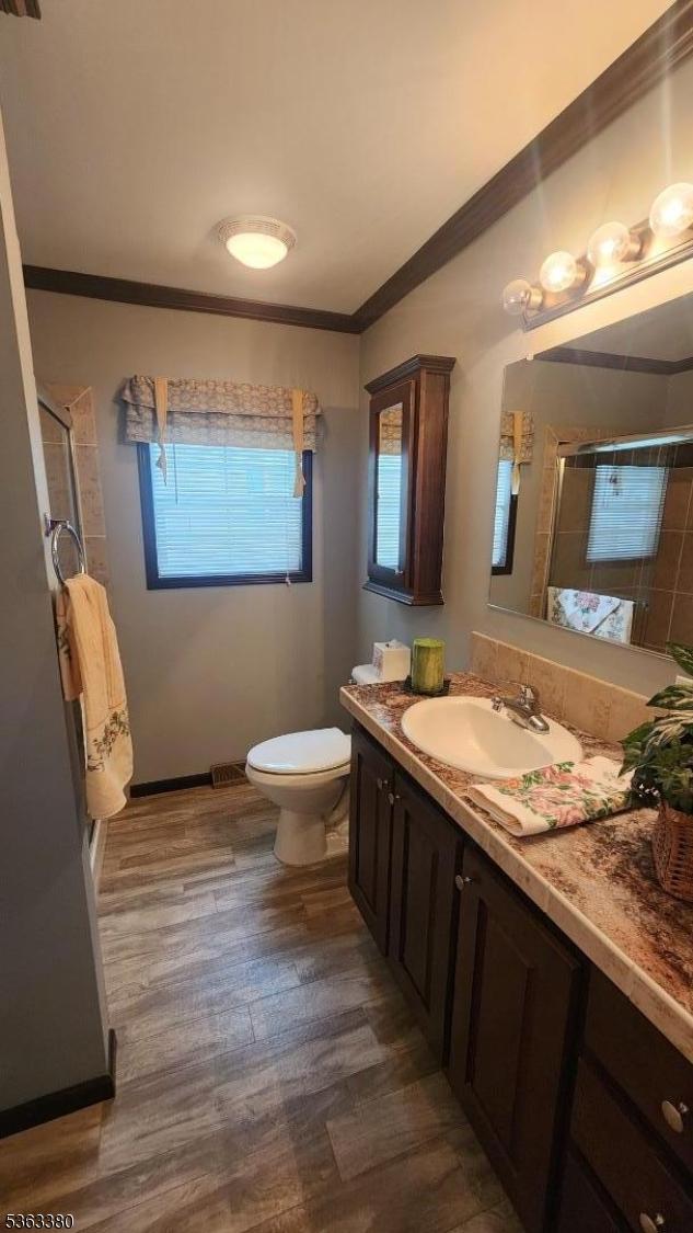 7 Makepeace Dr Unit 7, Jefferson Twp, NJ 07438 - bathroom with crown molding, a shower stall, vanity, and wood finished floors