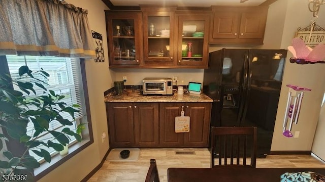 7 Makepeace Dr Unit 7, Jefferson Twp, NJ 07438 - kitchen with black refrigerator with ice dispenser, light stone counters, glass insert cabinets, and dark brown cabinetry