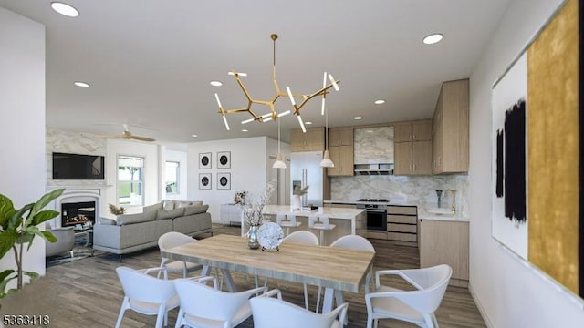 491 Central Ave Unit 4, New Providence Boro, NJ 07974 - dining area featuring a large fireplace, wood finished floors, recessed lighting, a ceiling fan, and a chandelier