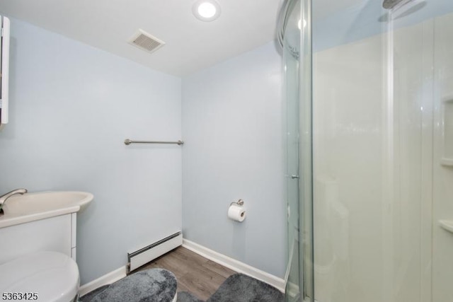56 Holsman St Unit 2, Paterson City, NJ 07522 - full bath with a baseboard radiator, a stall shower, and wood finished floors