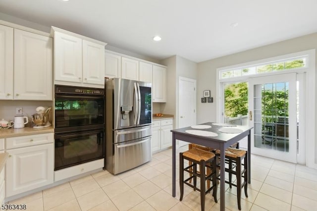 22 Young Ct, Chester Twp, NJ 07930 - kitchen featuring stainless steel refrigerator with ice dispenser, light tile patterned flooring, white cabinetry, light countertops, and recessed lighting