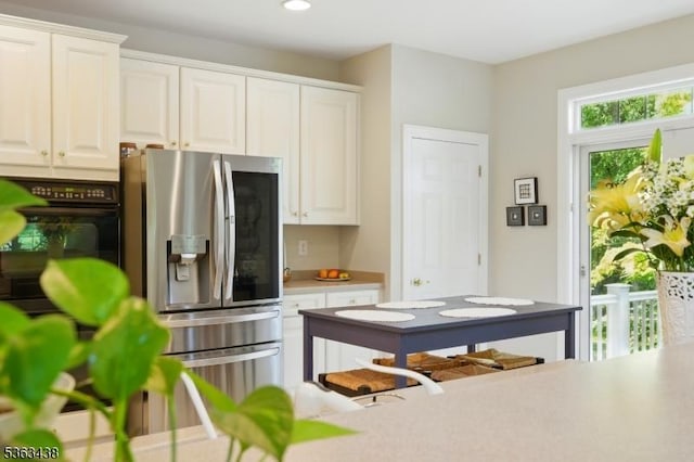 22 Young Ct, Chester Twp, NJ 07930 - kitchen featuring stainless steel refrigerator with ice dispenser, black oven, white cabinetry, light countertops, and recessed lighting