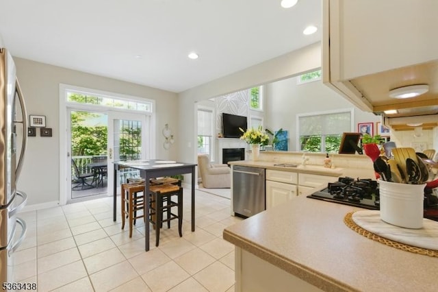 22 Young Ct, Chester Twp, NJ 07930 - kitchen featuring appliances with stainless steel finishes, a fireplace, light tile patterned flooring, recessed lighting, and light countertops