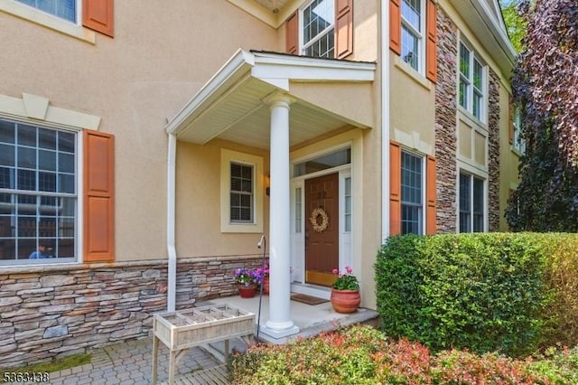 22 Young Ct, Chester Twp, NJ 07930 - doorway to property featuring stone siding, stucco siding, and covered porch