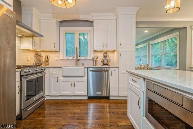 76 W Valley View Dr, Morristown Town, NJ 07960 - kitchen with appliances with stainless steel finishes, wall chimney exhaust hood, white cabinets, dark wood-type flooring, and decorative backsplash
