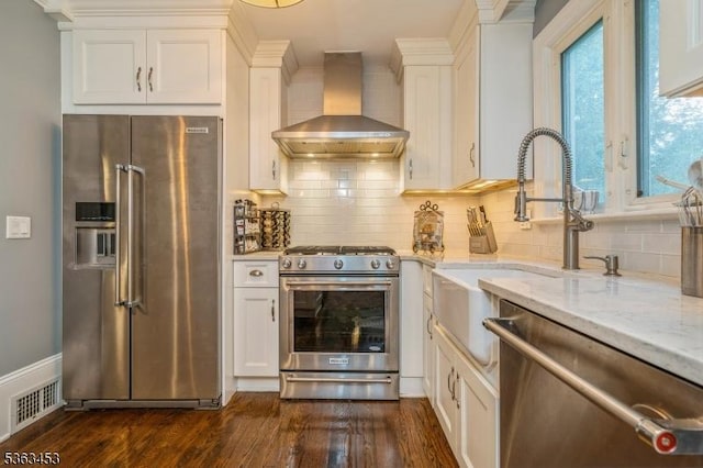 76 W Valley View Dr, Morristown Town, NJ 07960 - kitchen featuring appliances with stainless steel finishes, wall chimney exhaust hood, white cabinets, light stone countertops, and dark wood-type flooring