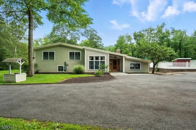 34 Millbrook Rd, Harding Twp, NJ 07976 - view of front facade with a chimney, asphalt driveway, and a front yard