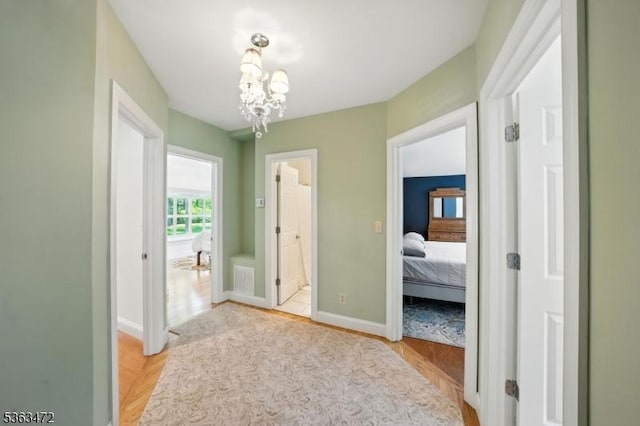 34 Millbrook Rd, Harding Twp, NJ 07976 - hallway featuring light wood-type flooring and a chandelier