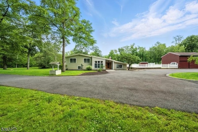 34 Millbrook Rd, Harding Twp, NJ 07976 - view of front facade with a chimney, asphalt driveway, and a front lawn