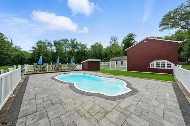 34 Millbrook Rd, Harding Twp, NJ 07976 - view of pool featuring a patio area, a fenced backyard, a storage unit, and view of scattered trees