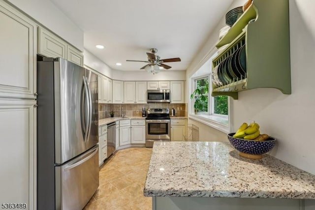 11 Wynding Way, Rockaway Twp, NJ 07866 - kitchen featuring appliances with stainless steel finishes, decorative backsplash, ceiling fan, light stone counters, and recessed lighting