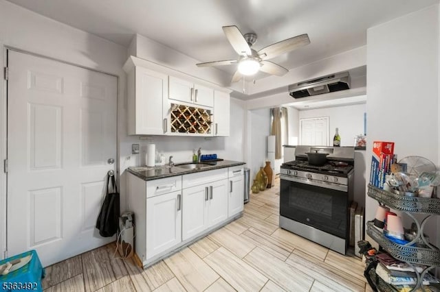459 Maple Ave Unit 2, Elizabeth City, NJ 07202 - kitchen with gas stove, a sink, dark countertops, white cabinets, and a ceiling fan
