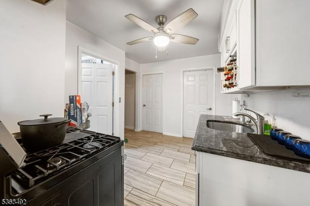 459 Maple Ave Unit 2, Elizabeth City, NJ 07202 - kitchen featuring a sink, dark stone countertops, white cabinets, ceiling fan, and black gas range