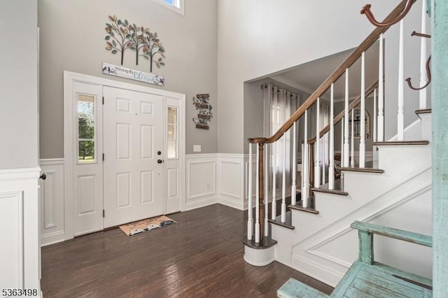 24 Eagles Nest Rd, Green Twp, NJ 07860 - entrance foyer featuring a wainscoted wall, wood finished floors, stairs, a decorative wall, and a towering ceiling