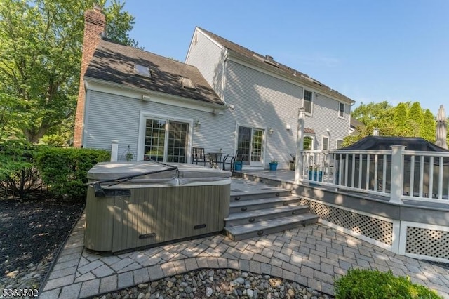 4 Fisher Ct, Raritan Twp, NJ 08822 - back of property with a hot tub, a wooden deck, and a chimney