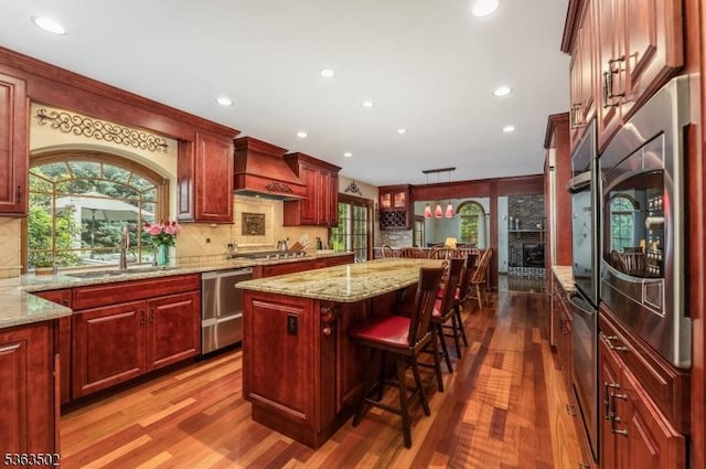 4 Fisher Ct, Raritan Twp, NJ 08822 - kitchen with custom range hood, appliances with stainless steel finishes, dark wood-style floors, dark brown cabinets, and a center island