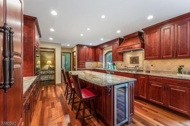 4 Fisher Ct, Raritan Twp, NJ 08822 - kitchen with beverage cooler, premium range hood, dark wood finished floors, dark brown cabinets, and recessed lighting