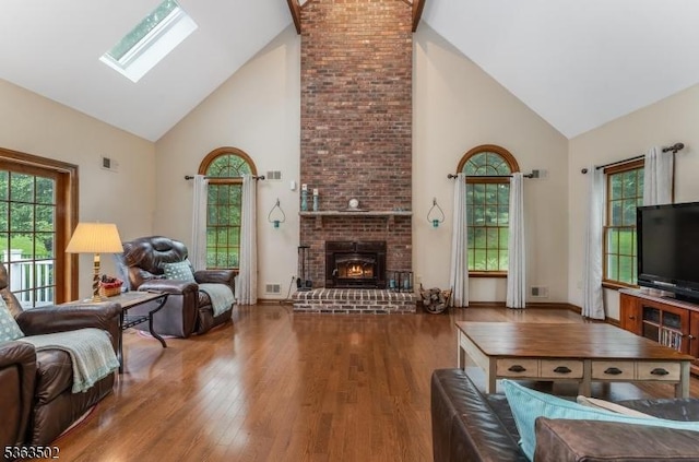 4 Fisher Ct, Raritan Twp, NJ 08822 - living area with high vaulted ceiling, wood finished floors, a skylight, healthy amount of natural light, and a brick fireplace