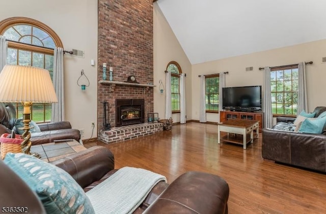 4 Fisher Ct, Raritan Twp, NJ 08822 - living room with high vaulted ceiling, wood finished floors, plenty of natural light, and a brick fireplace