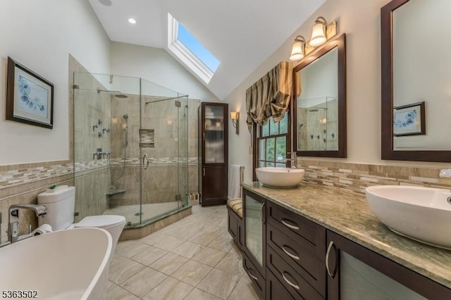4 Fisher Ct, Raritan Twp, NJ 08822 - bathroom featuring a stall shower, vaulted ceiling, a soaking tub, double vanity, and tile walls