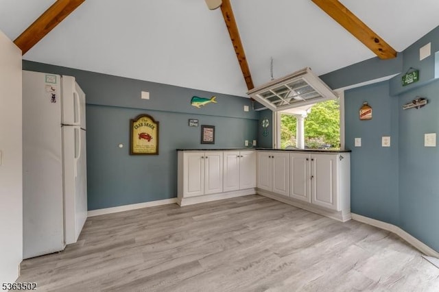 4 Fisher Ct, Raritan Twp, NJ 08822 - kitchen with freestanding refrigerator, beam ceiling, high vaulted ceiling, light wood-style floors, and dark countertops