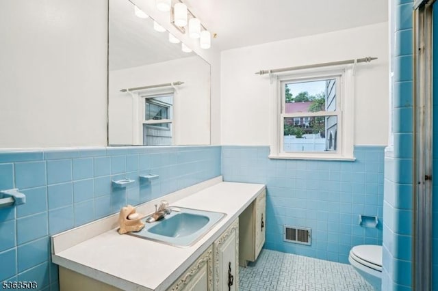 2 Linden Ave, West Orange Twp, NJ 07052 - bathroom featuring tile walls, tile patterned flooring, vanity, and wainscoting