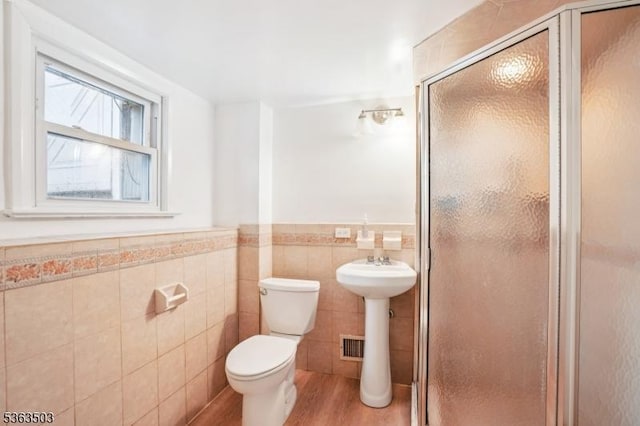 2 Linden Ave, West Orange Twp, NJ 07052 - full bathroom with tile walls, wood finished floors, a stall shower, and a wainscoted wall