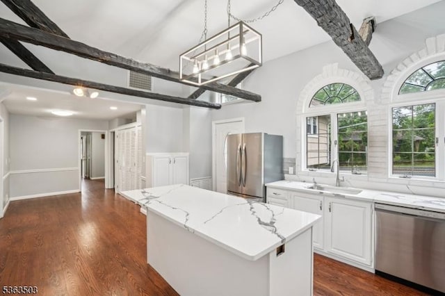 2 Linden Ave, West Orange Twp, NJ 07052 - kitchen featuring stainless steel appliances, a center island, light stone countertops, dark wood-style floors, and white cabinets