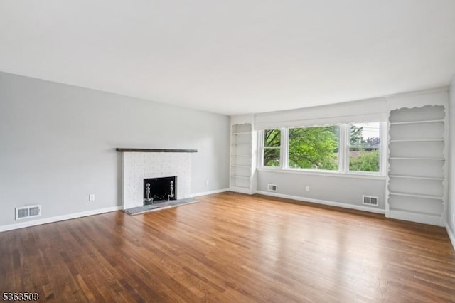 2 Linden Ave, West Orange Twp, NJ 07052 - unfurnished living room with wood finished floors, a fireplace, and built in shelves