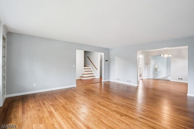 2 Linden Ave, West Orange Twp, NJ 07052 - spare room with a chandelier, stairway, and light wood-style flooring