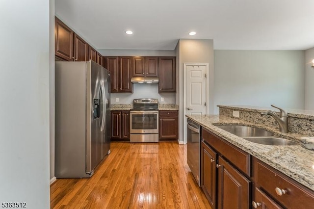 84 Washington Square Cir, Washington Boro, NJ 07882 - kitchen with appliances with stainless steel finishes, under cabinet range hood, light wood-style flooring, light stone counters, and recessed lighting