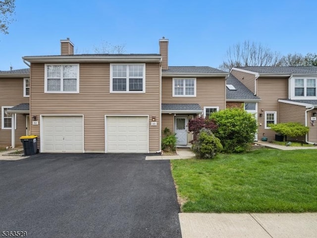 33 Avebury Pl, Franklin Twp, NJ 08873 - view of front of home featuring driveway, a chimney, an attached garage, and a front yard