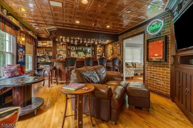 5 Brendan Dr, Mount Olive Twp, NJ 07836 - living area featuring an ornate ceiling, brick wall, wood finished floors, and bar area