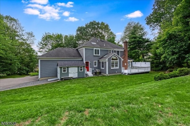 5 Brendan Dr, Mount Olive Twp, NJ 07836 - rear view of house with entry steps, a yard, asphalt driveway, and view of scattered trees