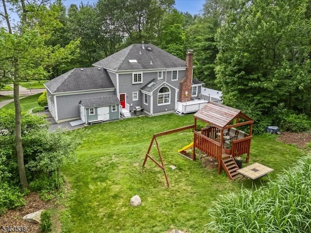 5 Brendan Dr, Mount Olive Twp, NJ 07836 - back of property with a playground, roof with shingles, a yard, a deck, and a chimney
