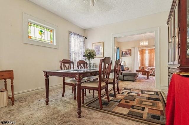 255 Ampere Pkwy, Bloomfield Twp, NJ 07003 - carpeted dining space with a textured ceiling and a chandelier