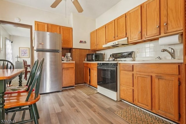 255 Ampere Pkwy, Bloomfield Twp, NJ 07003 - kitchen featuring freestanding refrigerator, white stove, under cabinet range hood, black microwave, and light countertops