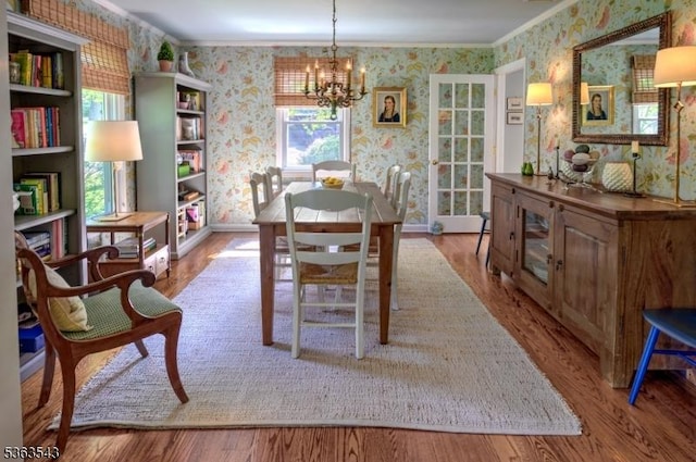 21 Sycamore Hill Rd, Bernardsville Boro, NJ 07924 - dining area featuring wallpapered walls, a chandelier, wood finished floors, and crown molding