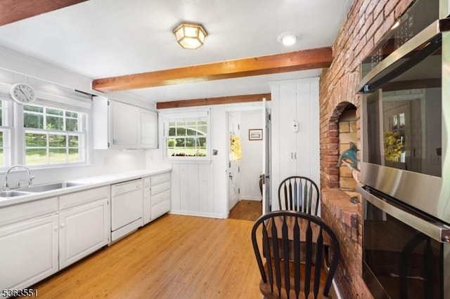 12 Schoolhouse Ln, Morris Twp, NJ 07960 - kitchen with white dishwasher, light wood-style flooring, beam ceiling, white cabinetry, and double oven