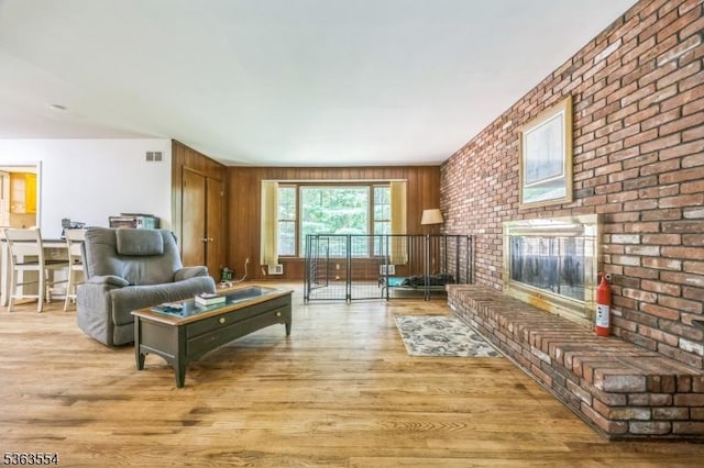 3 Christine Ct, Kinnelon Boro, NJ 07405 - living area with light wood-style floors, a fireplace, and brick wall