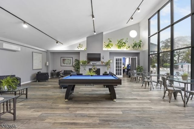 2467 State Route 10, Parsippany-Troy Hills Twp, NJ 07950 - playroom featuring track lighting, a wall mounted AC, high vaulted ceiling, and wood finished floors